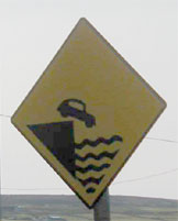 Car in drink road sign